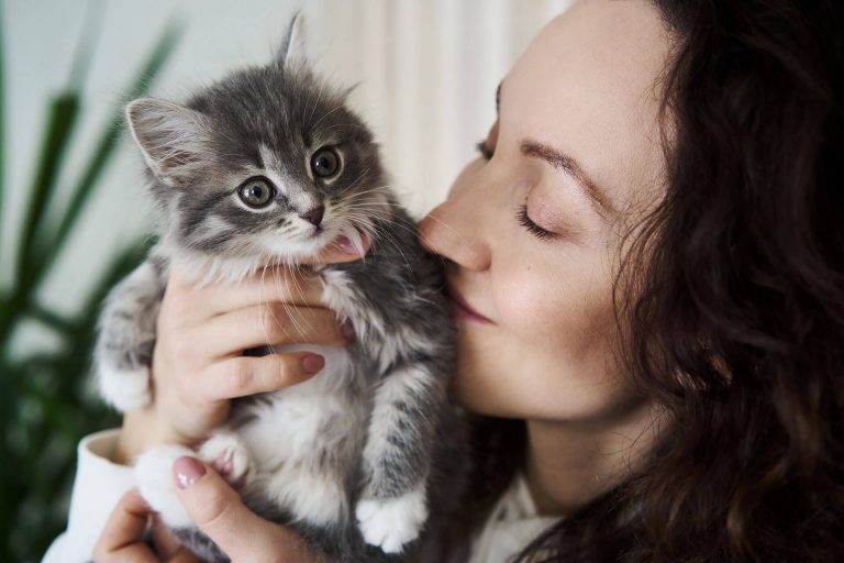 young woman holding kitten